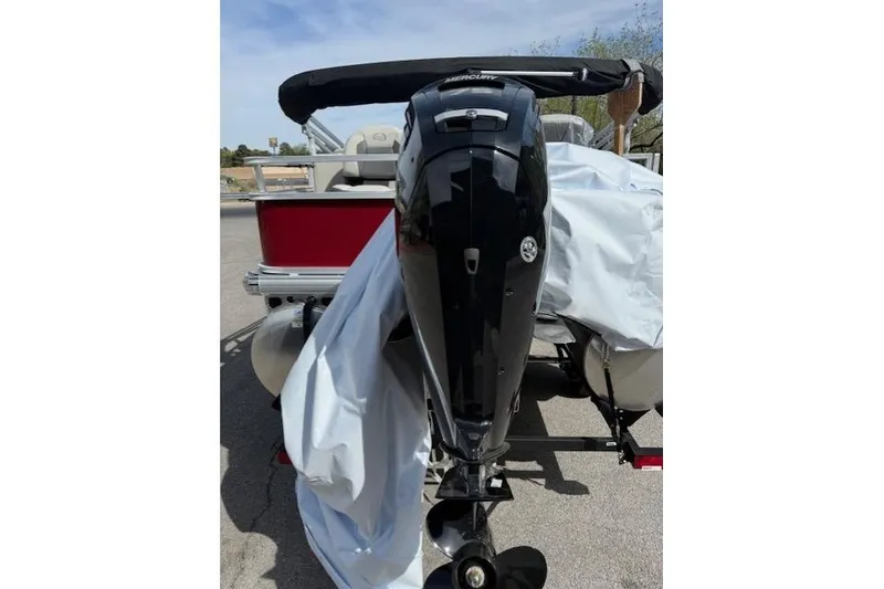 Slide: The Image of 2026 Sun Tracker Bass Buggy 18 DLX with Mercury outboard motor, rear view. - 4