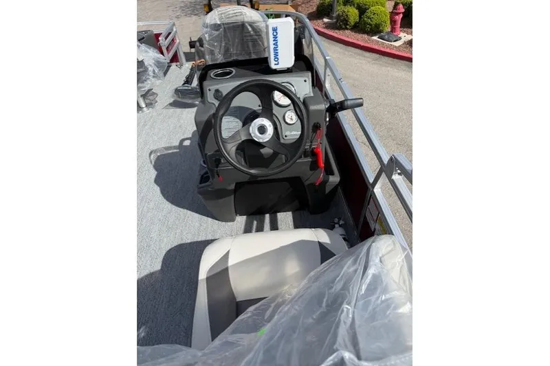 Slide: The Image of 2026 Sun Tracker Bass Buggy 18 DLX boat dashboard with steering wheel and controls. - 6