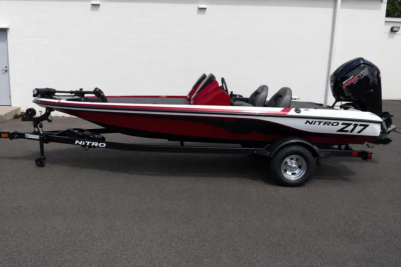 The Image of 2026 Nitro Z17 boat on trailer, red and white design, parked outdoors. - 0