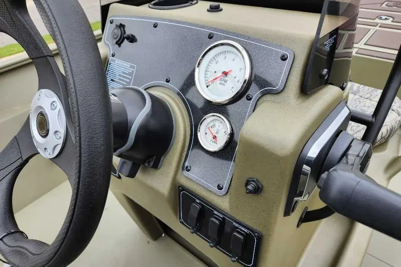 Slide: The Image of Steering console of 2026 Tracker Grizzly 2072 CC with gauges and controls. - 52