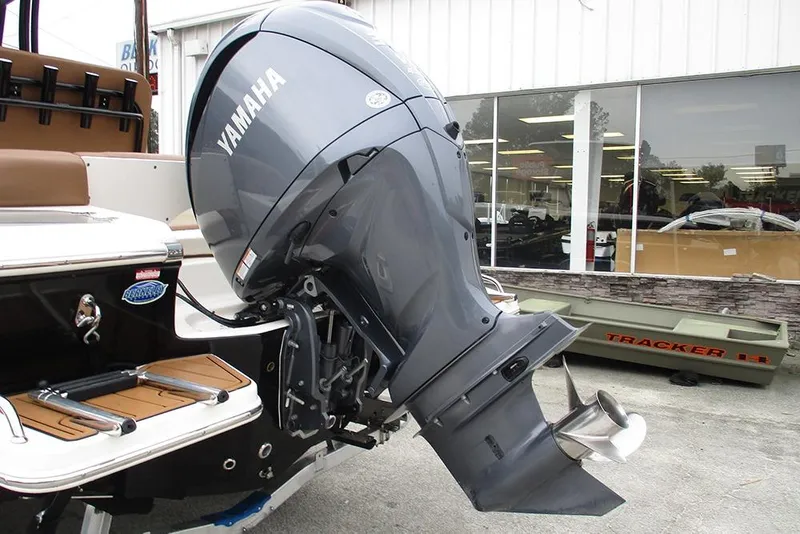 Slide: The Image of 2025 Pioneer 222 Islander boat with Yamaha outboard motor displayed outdoors. - 10