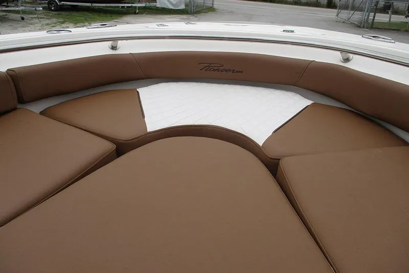Slide: The Image of 2025 Pioneer 222 Islander boat interior with brown cushioned seating. - 12