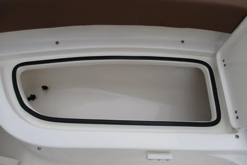 Slide: The Image of Storage compartment of 2025 Pioneer 222 Islander boat, featuring a sleek, white interior design. - 18