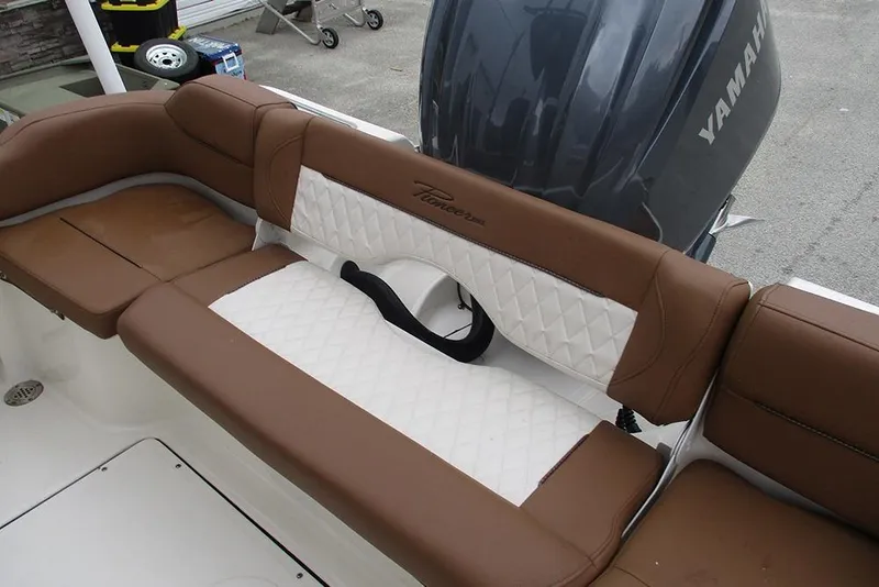 Slide: The Image of 2025 Pioneer 222 Islander boat with brown and white cushioned seating, Yamaha engine visible. - 22