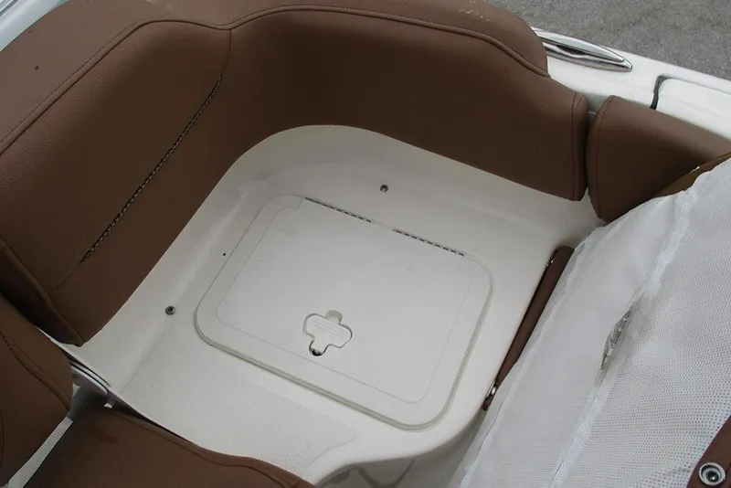 Slide: The Image of Brown seating area on 2025 Pioneer 222 Islander boat with storage compartment. - 26