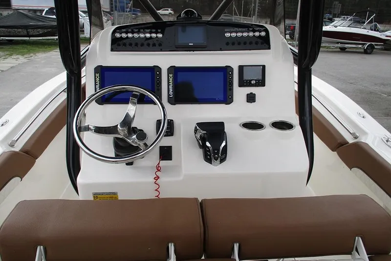 Slide: The Image of 2025 Pioneer 222 Islander boat dashboard with steering wheel and navigation screens. - 30