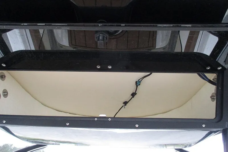 Slide: The Image of Storage compartment of 2025 Pioneer 222 Islander boat, featuring secure latches and wiring. - 33