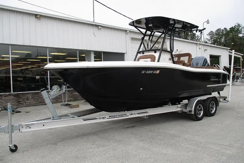 Slide: The Image of 2025 Pioneer 222 Islander boat on trailer outside a showroom. - 4