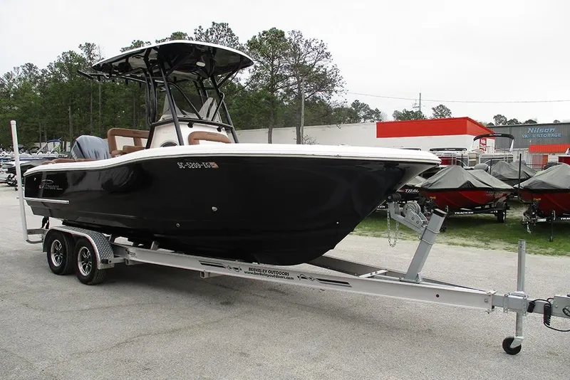 Slide: The Image of 2025 Pioneer 222 Islander boat on trailer in outdoor dealership setting. - 6