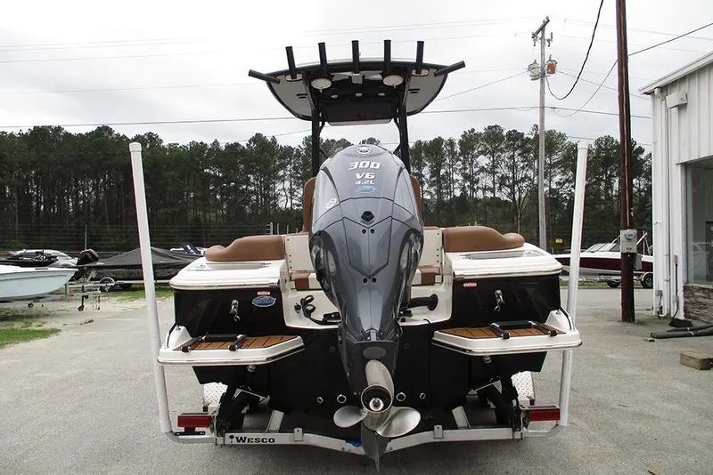 Slide: The Image of 2025 Pioneer 222 Islander boat with powerful outboard motor, parked outdoors. - 9