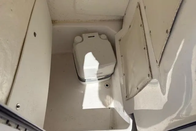 Slide: The Image of Portable toilet inside 2024 NauticStar 211 Hybrid boat compartment. - 13