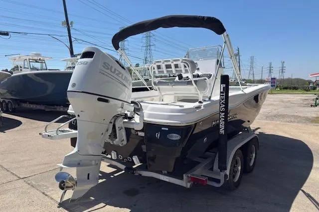 Slide: The Image of 2024 NauticStar 211 Hybrid boat on trailer with Suzuki outboard motor. - 5