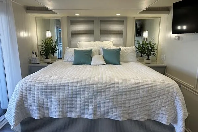 Slide: The Image of Luxurious bedroom in a 1999 Sumerset 18x82 houseboat with elegant decor and cozy bedding. - 10