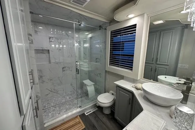 Slide: The Image of Luxurious bathroom in 1999 Sumerset 18x82 houseboat with modern fixtures and marble shower. - 12