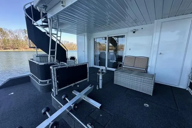 Slide: The Image of 1999 Sumerset 18x82 houseboat deck with spiral staircase and outdoor seating. - 13