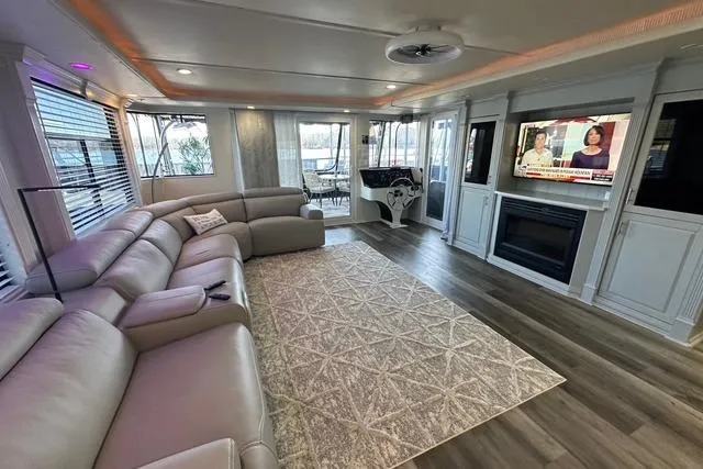 Slide: The Image of Luxurious 1999 Sumerset 18x82 houseboat interior with modern living area, large sofa, and TV. - 3