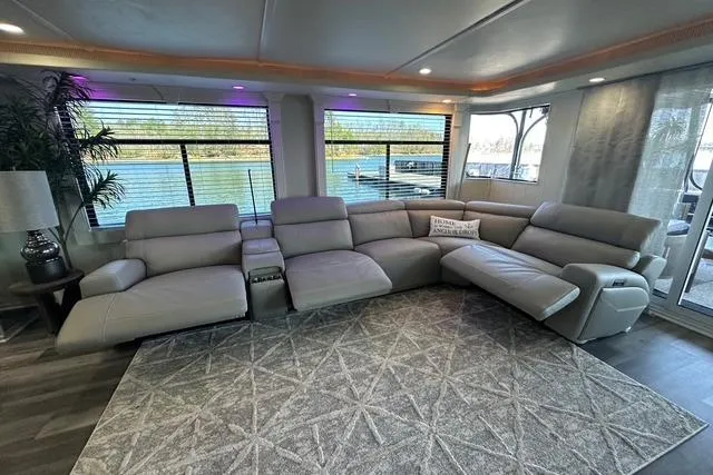 Slide: The Image of Luxurious interior of a 1999 Sumerset 18x82 houseboat with plush seating and scenic water views. - 4