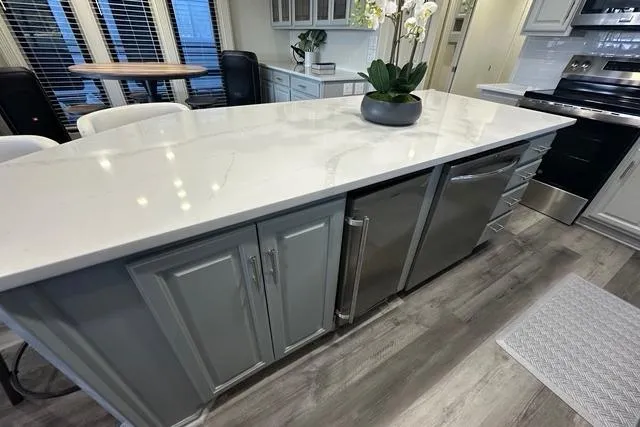 Slide: The Image of Luxurious kitchen interior of a 1999 Sumerset 18x82 houseboat with modern appliances. - 6