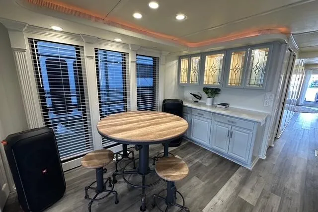 Slide: The Image of Modern dining area in a 1999 Sumerset 18x82 houseboat with round table and stools. - 7
