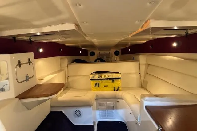 Slide: The Image of Interior of 1984 Cigarette 35' Cafe Racer boat with beige seating and life jackets. - 10