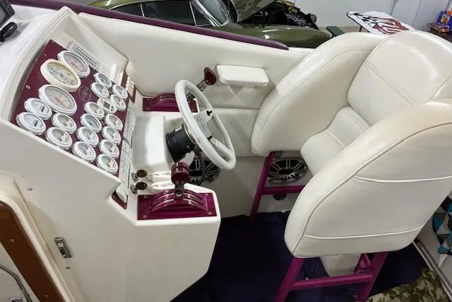 Slide: The Image of 1984 Cigarette 35' Cafe Racer cockpit with white seats and multiple gauges. - 11