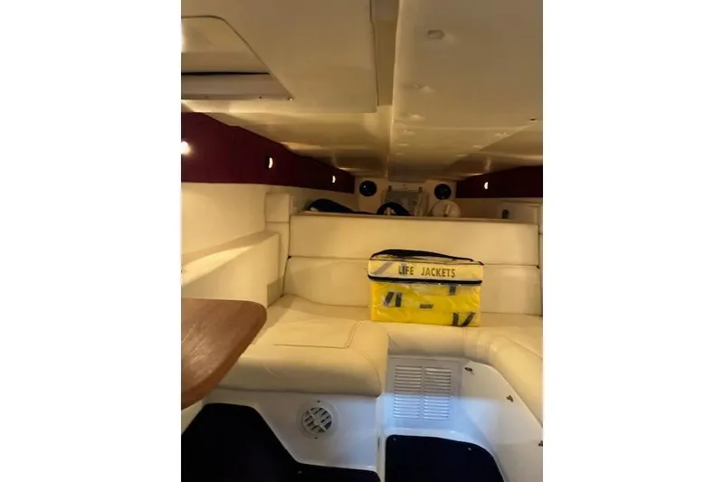 Slide: The Image of Interior of 1984 Cigarette 35' Cafe Racer boat with life jackets on white seating. - 13