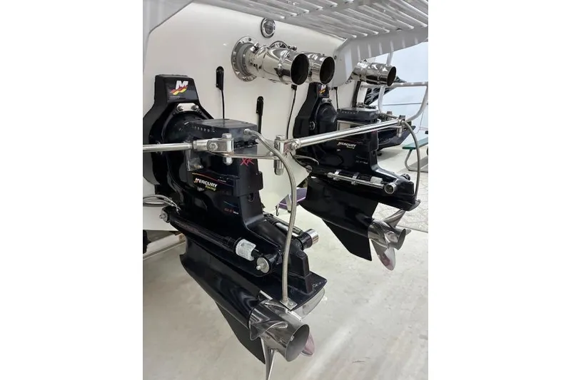 Slide: The Image of 1984 Cigarette 35' Cafe Racer boat engines with Mercury outdrives, showcasing performance features. - 3