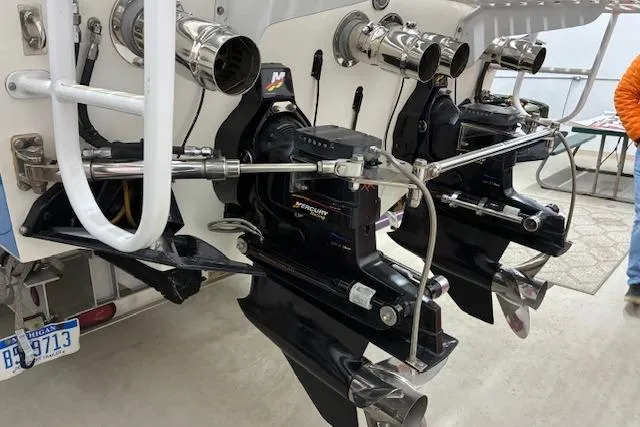 Slide: The Image of 1984 Cigarette 35' Cafe Racer boat engines and propellers in a garage setting. - 4