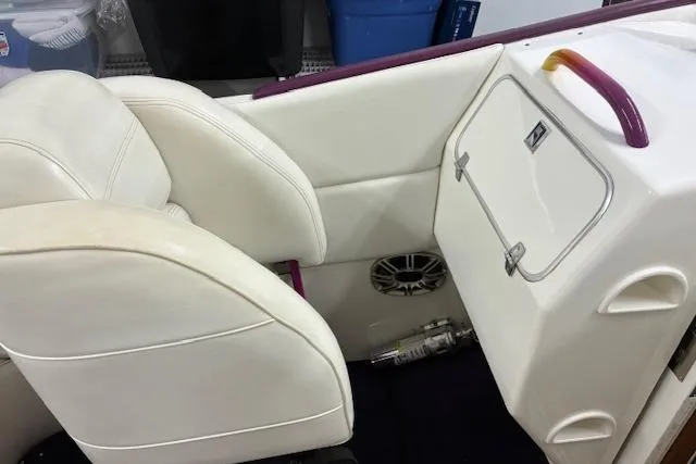 Slide: The Image of 1984 Cigarette 35' Cafe Racer interior with white seating and storage compartment. - 7