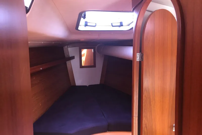 Slide: The Image of Cozy cabin interior of 2004 J Boats J/133 sailboat with wooden finish and skylight. - 11