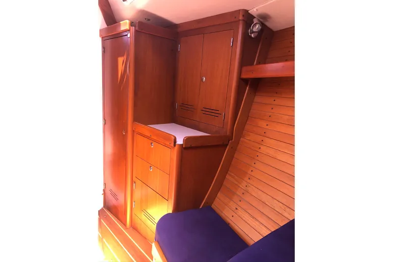 Slide: The Image of Interior of 2004 J Boats J/133, featuring wooden cabinetry and seating. - 13
