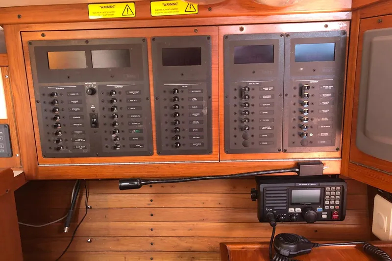 Slide: The Image of Electrical control panel on a 2004 J Boats J/133 yacht, featuring various switches and a radio. - 17