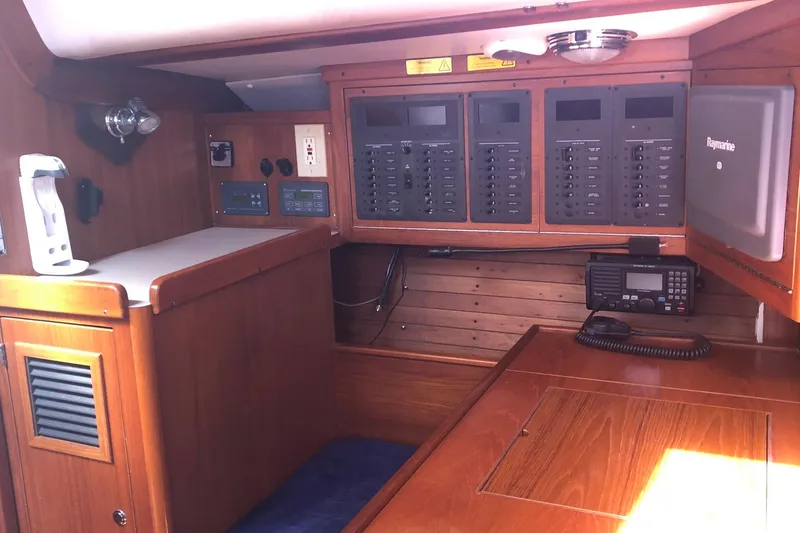 Slide: The Image of Interior of 2004 J Boats J/133 yacht with navigation equipment and wooden cabinetry. - 18