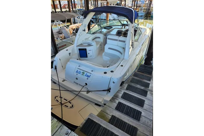 Slide: The Image of 2005 Sea Ray Sundancer 320 docked, featuring spacious seating and sleek design. - 11
