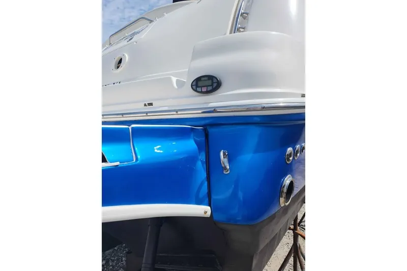 Slide: The Image of 2005 Sea Ray Sundancer 320 boat with blue and white exterior detailing. - 12