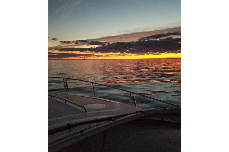 Slide: The Image of Sea Ray Sundancer 320 boat at sunset on calm waters, 2005 model. - 13