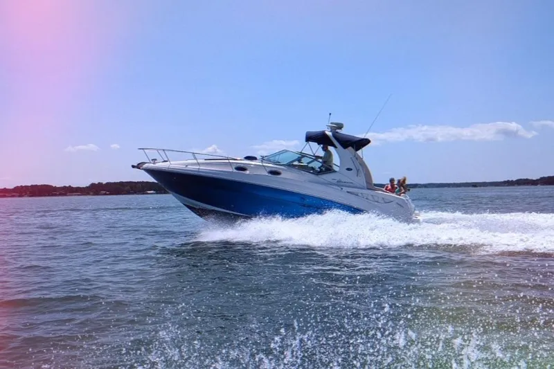 Slide: The Image of 2005 Sea Ray Sundancer 320 cruising on open water under clear skies. - 15