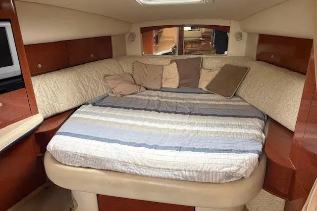 Slide: The Image of Interior cabin of 2005 Sea Ray Sundancer 320 with cozy bed and pillows. - 25