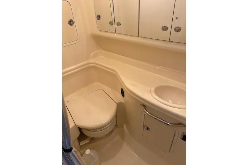 Slide: The Image of Compact bathroom in 2005 Sea Ray Sundancer 320 yacht, featuring toilet and sink. - 26