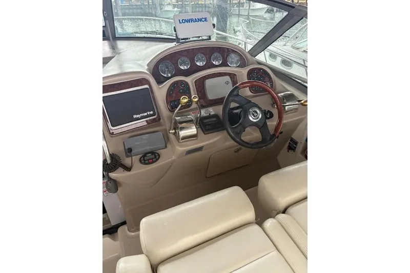 Slide: The Image of Helm of 2005 Sea Ray Sundancer 320 with navigation equipment and steering wheel. - 29