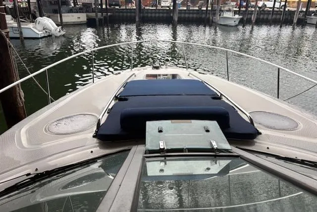 Slide: The Image of 2005 Sea Ray Sundancer 320 yacht docked, featuring a sleek bow and spacious deck. - 30