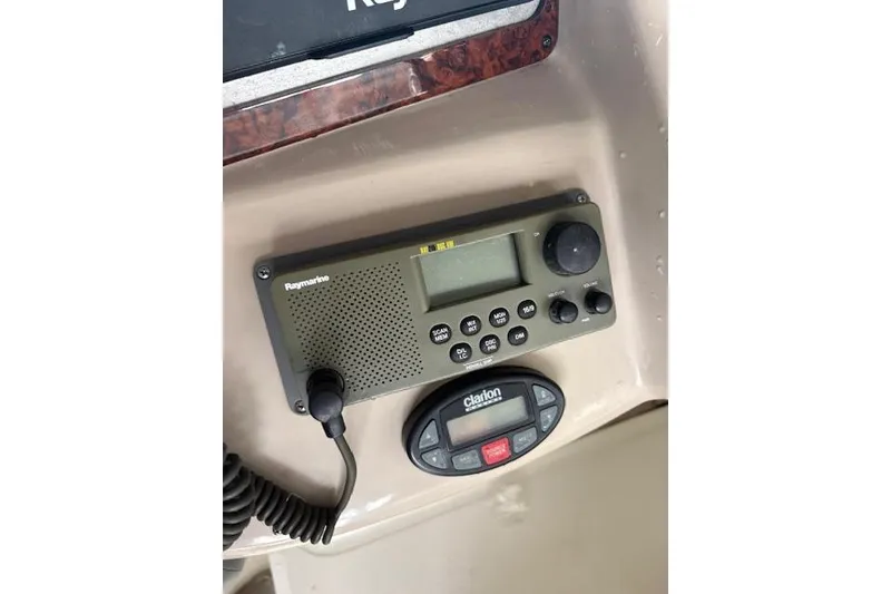 Slide: The Image of Raymarine radio and Clarion control panel on 2005 Sea Ray Sundancer 320 boat dashboard. - 33