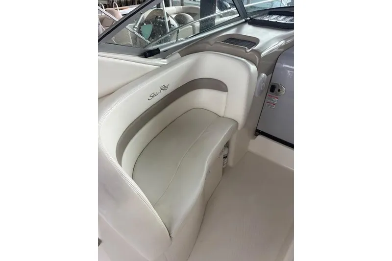 Slide: The Image of 2005 Sea Ray Sundancer 320 interior seating with beige upholstery and logo. - 37