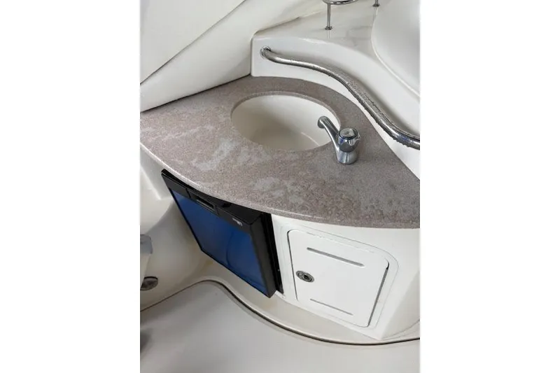 Slide: The Image of 2005 Sea Ray Sundancer 320 boat interior with sink, countertop, and storage cabinet. - 38