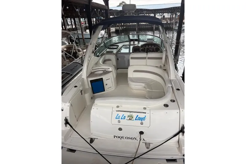 Slide: The Image of 2005 Sea Ray Sundancer 320 boat docked, featuring spacious seating and "La La Land" signage. - 40