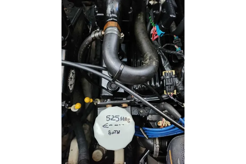 Slide: The Image of Engine compartment of a 2005 Sea Ray Sundancer 320 with visible hoses and wiring. - 5