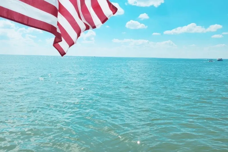 Slide: The Image of American flag waving over ocean, clear sky, Sea Ray Sundancer 320, 2005 model. - 9