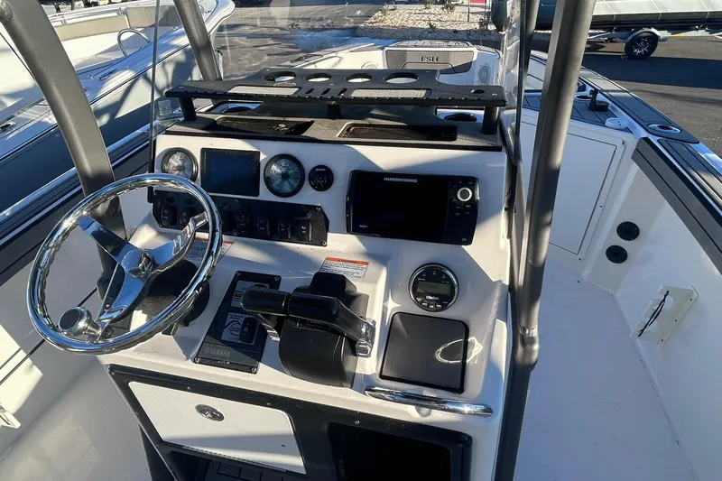 Slide: The Image of 2019 Yamaha Boats 210 FSH Sport dashboard with steering wheel and controls. - 10