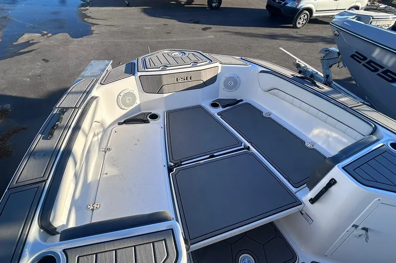Slide: The Image of 2019 Yamaha Boats 210 FSH Sport interior, featuring spacious seating and storage compartments. - 11