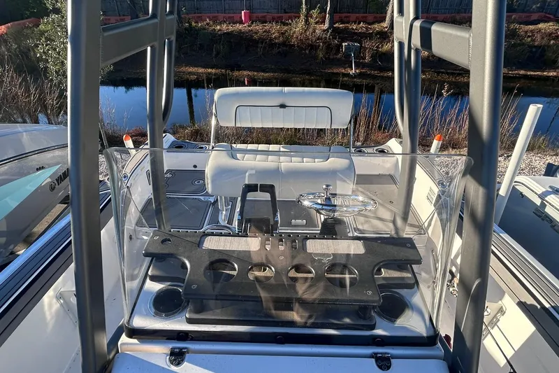 Slide: The Image of 2019 Yamaha Boats 210 FSH Sport cockpit with steering wheel and seating. - 12